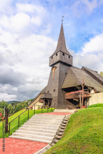 Obraz na płótnie The wooden parish church of the Finding of the Holy Cross in the district Głębce in the tourist town - Wisła in the Silesian Beskids (Poland). w salonie