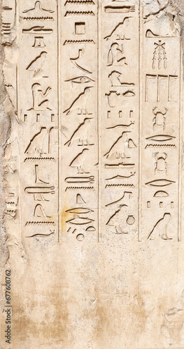 Ancient Egyptian hieroglyphs on stone wall, Karnak Temple Complex, Luxor, Egypt, Africa. Stone carvings with hieroglyphs at Karnak temple, Luxor, Thebes