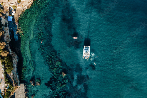 Amazing top view of Catamaran anchored in blue sea. Travel background.