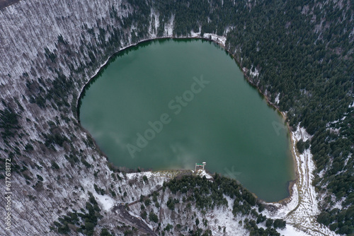Aerial Drone View of a Volcanic Crater Lake at Winter. Flying Above Sfanta Ana Lake, Szent Anna Lake, Szeklerland, Transylvania, Romania