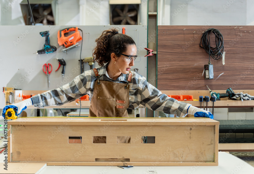 Carpenter woman one smile young aged standing aim working on wood plank