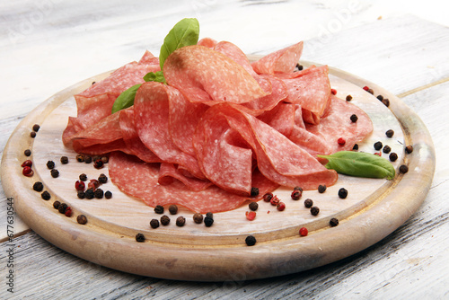 thinly sliced salami, delicious snack rustic salami on table