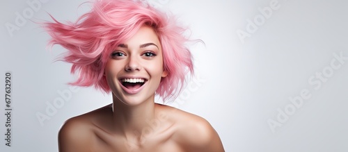 The woman with a white background is isolated but her cute and funny personality shines through as she embraces her pink hair and flawless skin showcasing her beauty and captivating face