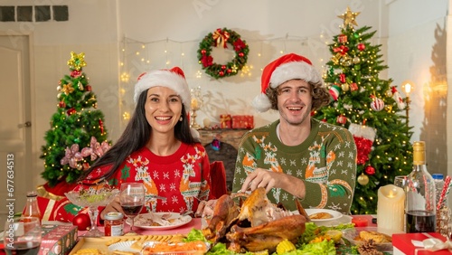 couple lover celebration kiss feed food together in Christmas thanksgiving day. enjoy happy party to have dinner together with full food of turkey drink and present for celebrate merry Christmas