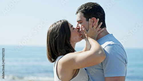 Beautiful couple standing together kissing at seaside © Krakenimages.com