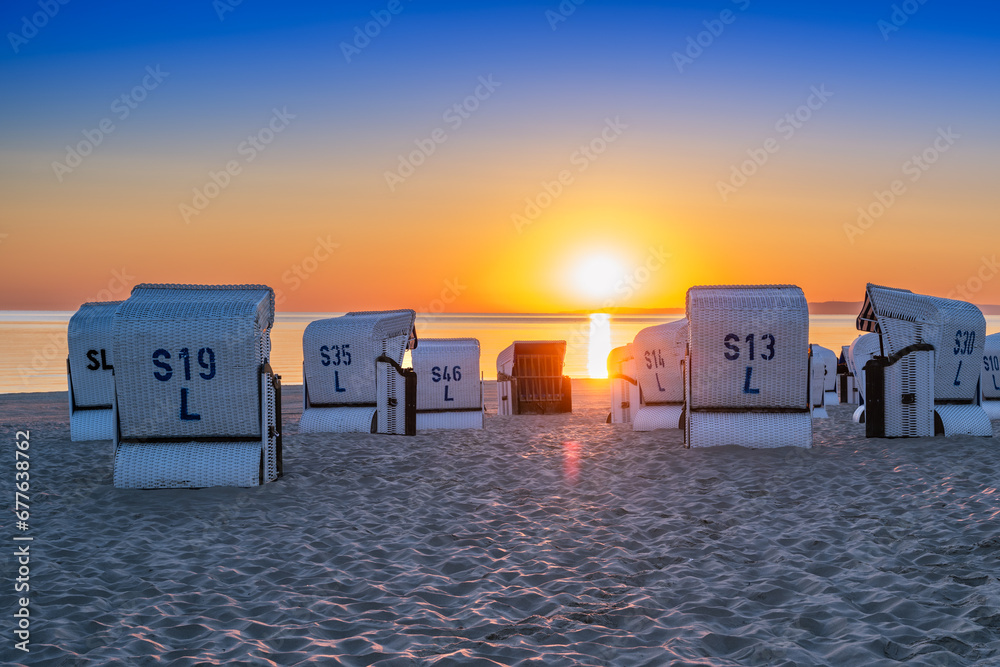 Sunrise on the beach by the Baltic Sea with beach chairs - obrazy, fototapety, plakaty 