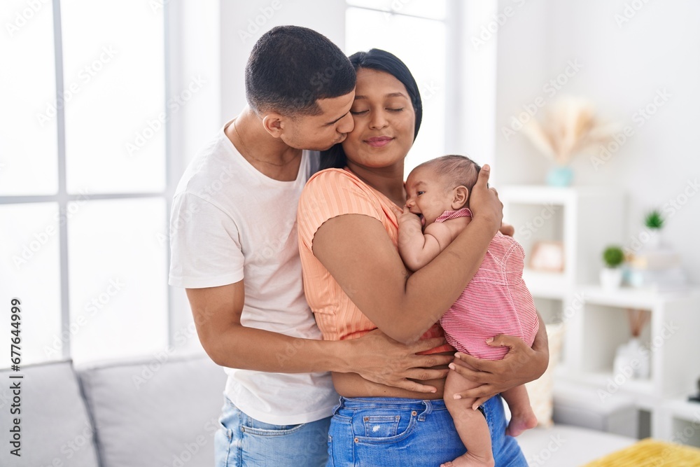 Hispanic family hugging each other kissing at home Hispanic family hugging each other kissing at home