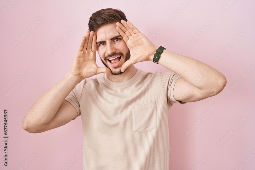Hispanic man with beard standing over pink background smiling cheerful playing peek a boo with hands showing face. surprised and exited Hispanic man with beard standing over pink background smiling cheerful playing peek a boo with hands showing face. surprised and exited