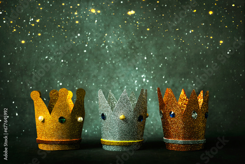 Three crowns of the three wise men and christmas lights. Concept for Reyes Magos day. Three Wise Men concept photo