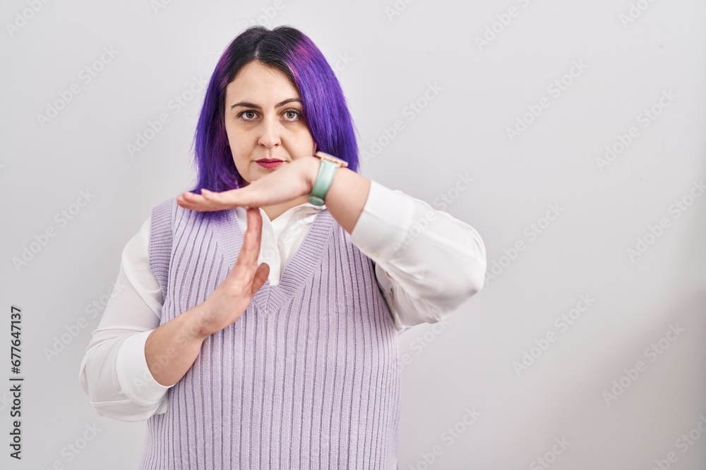 Plus size woman wit purple hair standing over white background doing time out gesture with hands, frustrated and serious face Plus size woman wit purple hair standing over white background doing time out gesture with hands, frustrated and serious face