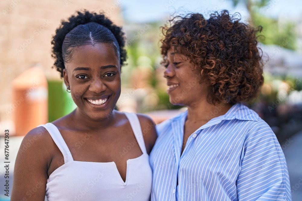 African american women mother and daughter standing together at street African american women mother and daughter standing together at street
