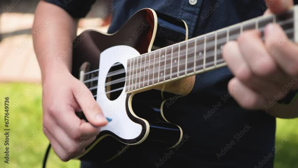Close up of man hand playing guitar during the daytime outdoor. Close up of man hand playing guitar during the daytime outdoor.