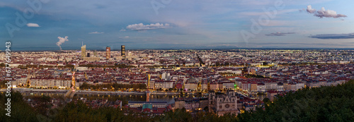 Panorama of Lyon from Fourviere hill in the early evening  showing city lights and distant alps mountains  Lyon  France