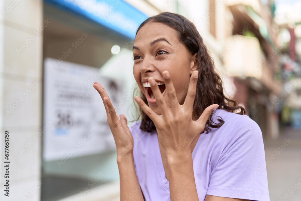 Young african american woman standing with surprise expression at street Young african american woman standing with surprise expression at street