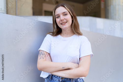 Free Download Young caucasian woman standing with arms crossed gesture at street - GFXLoad