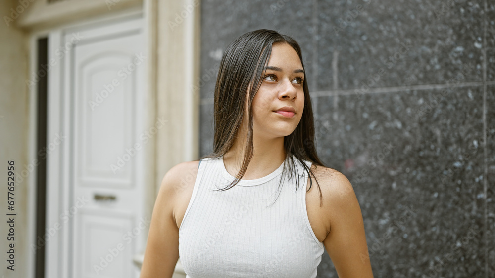 Young beautiful hispanic woman looking to the side with serious expression at street Young beautiful hispanic woman looking to the side with serious expression at street