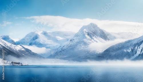 Awesome mountain winter landscape with snow capped mountains with blue lake in front. Nature and travel concept © grahof_photo