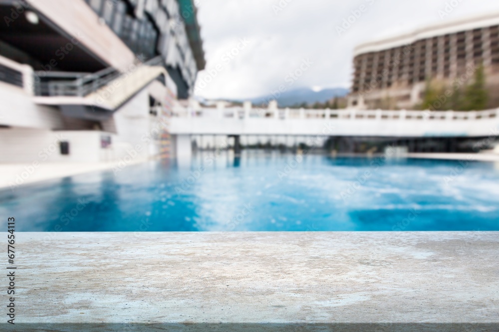 Empty table on swimming pool background in tropical resort Empty table on swimming pool background in tropical resort