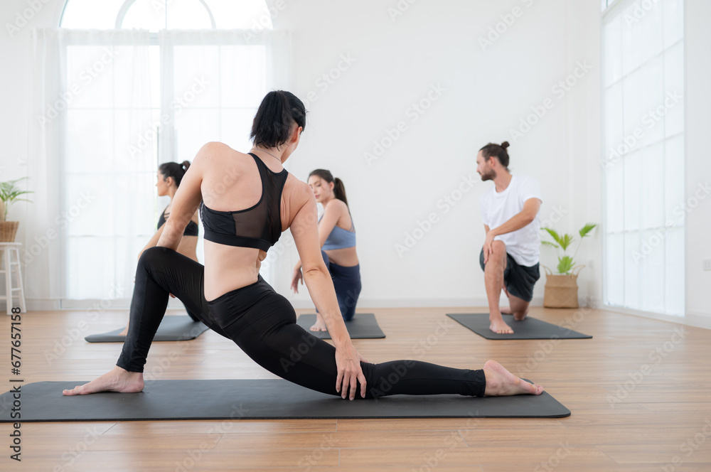 Group of people practicing yoga in a studio. Yoga class concept. Group of people practicing yoga in a studio. Yoga class concept.