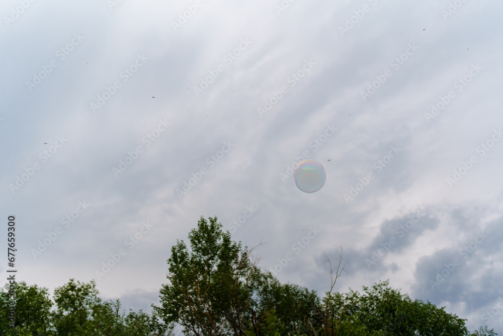 Soap bubble on the background of an overcast sky. Soap bubble on the background of an overcast sky.