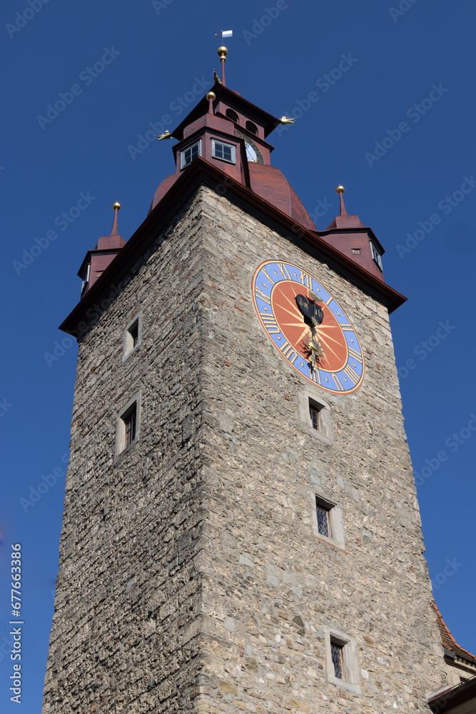Clock tower near baroque church, switzerland, lucerne