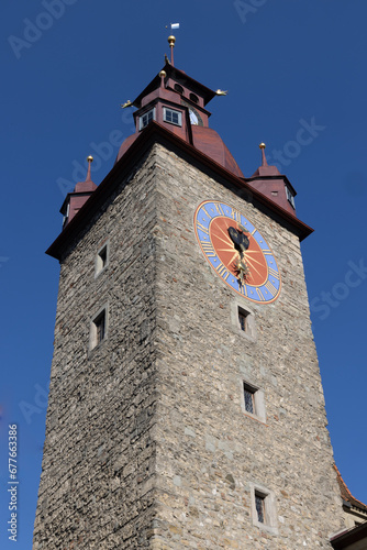 Clock tower near baroque church, switzerland, lucerne