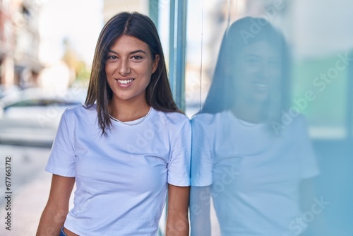 Young beautiful hispanic woman smiling confident standing at street