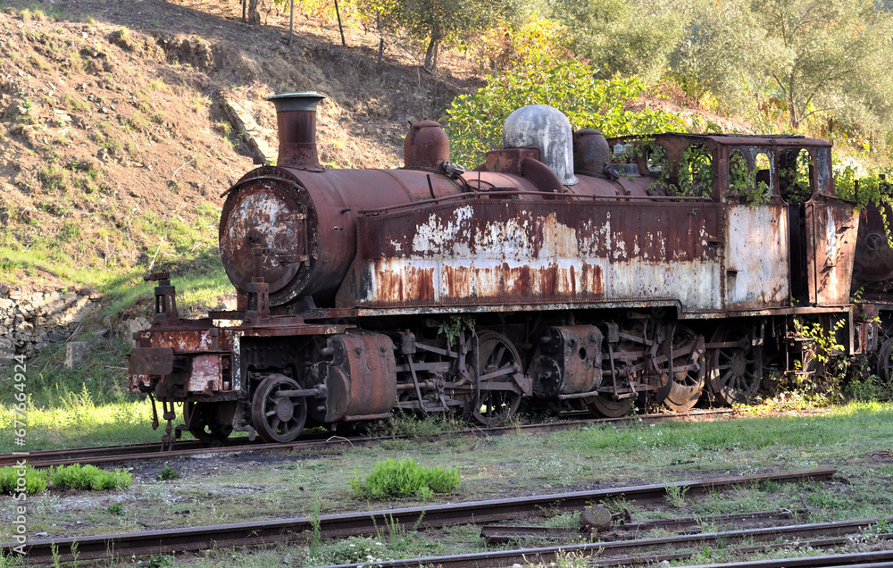 Abandoned, aged, rusty steam locomotive, pieces of track from a closed line