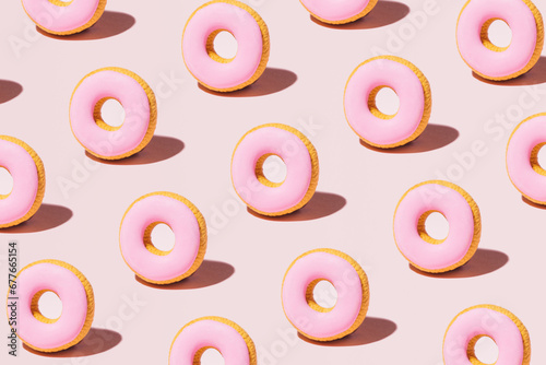 Pastel pink glazed donuts, creative bakery pattern.