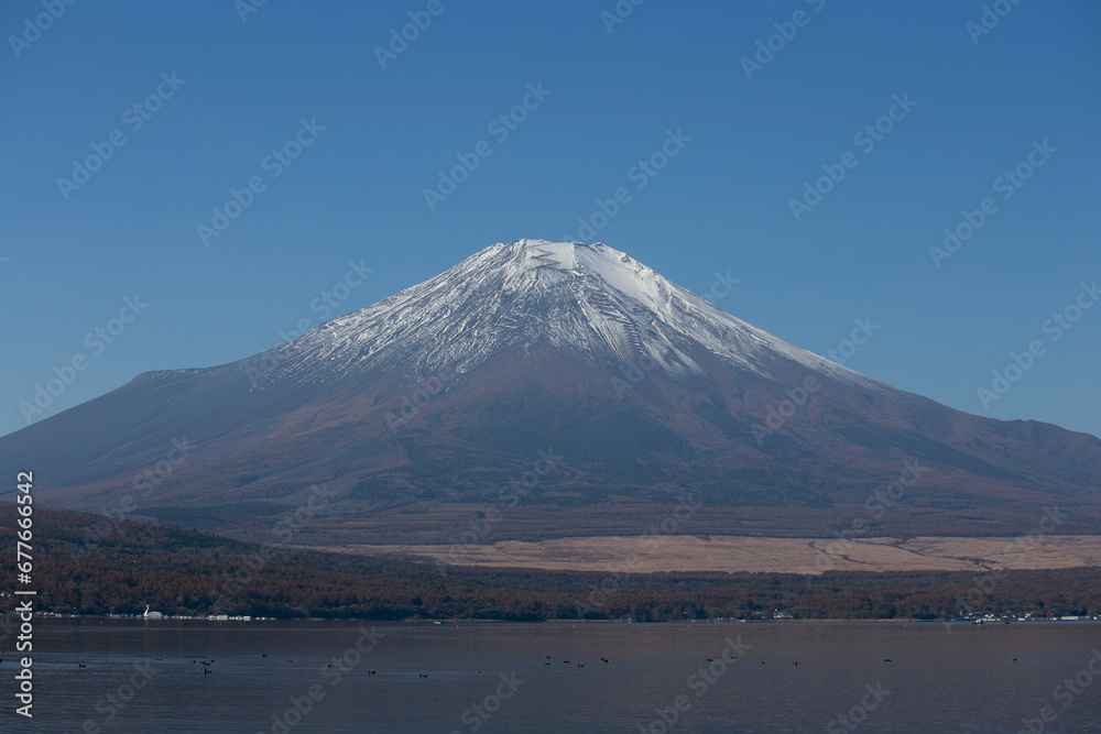 Views  of Mount Fuji covered in snow from Yamanaka lake in Yamanakako, Japan.