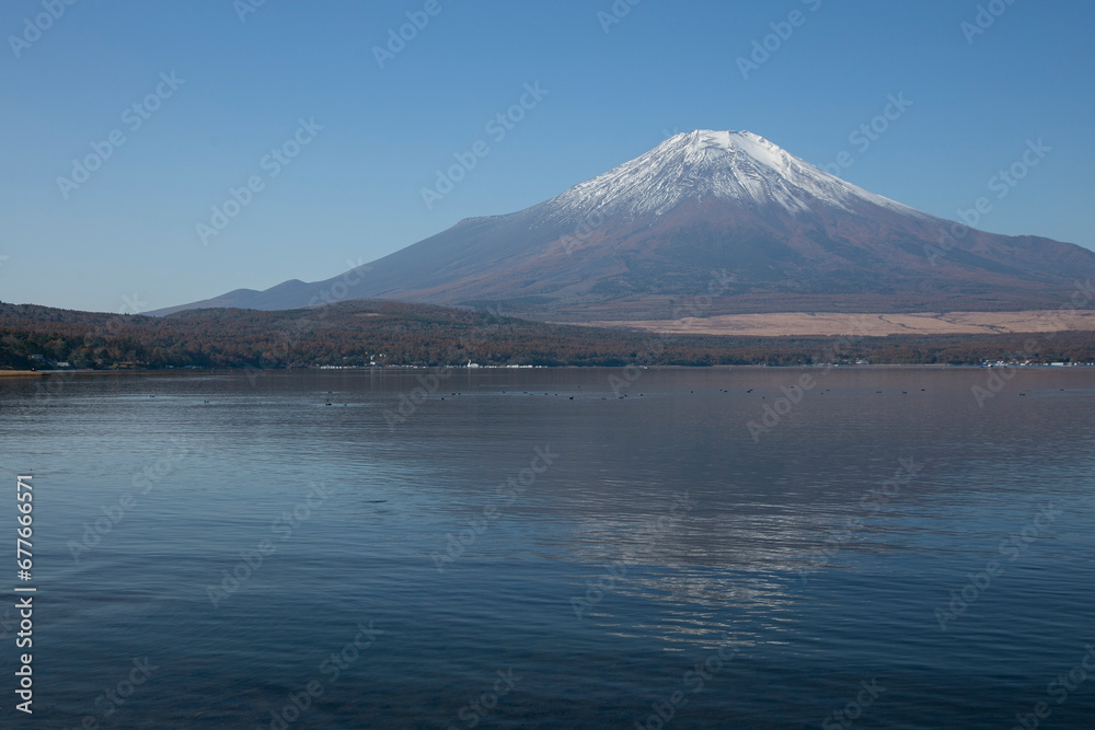 Views  of Mount Fuji covered in snow from Yamanaka lake in Yamanakako, Japan.