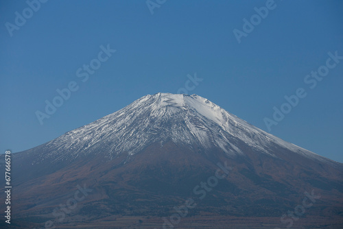 Views of Mount Fuji covered in snow from Yamanaka lake in Yamanakako, Japan.