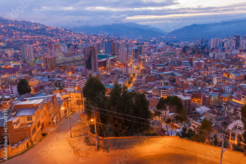 View of La Paz downtown at sunset surrounded by mountains in Bolivia.