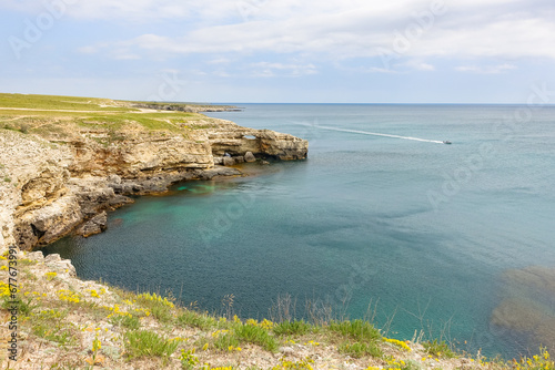 Cape Tarkhankut on the Crimean peninsula. The rocky coast of the Dzhangul Reserve in the Crimea. The Black Sea. Turquoise sea water. Rocks and grottoes of Cape Tarkhankut. photo