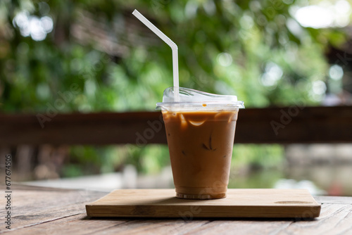 ice coffee in the take away plastic cup in garden