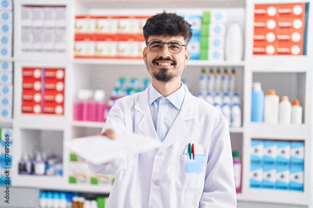Young hispanic man pharmacist smiling confident holding prescription at pharmacy