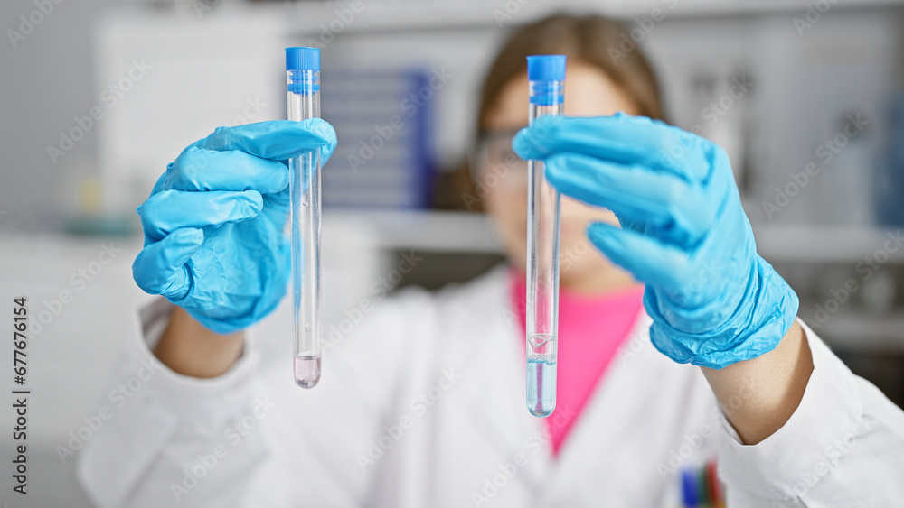 Young, attractive hispanic woman scientist at work in the lab, expertly measuring and analyzing test tubes - portrait of a dedicated professional balancing beauty and brain Young, attractive hispanic woman scientist at work in the lab, expertly measuring and analyzing test tubes - portrait of a dedicated professional balancing beauty and brain