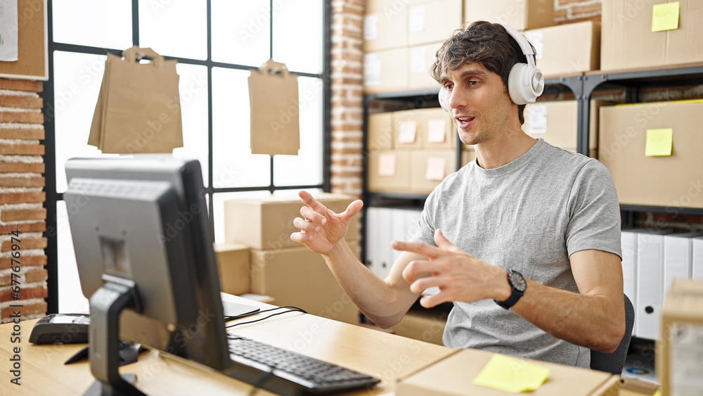 Young hispanic man ecommerce business worker having video call at office