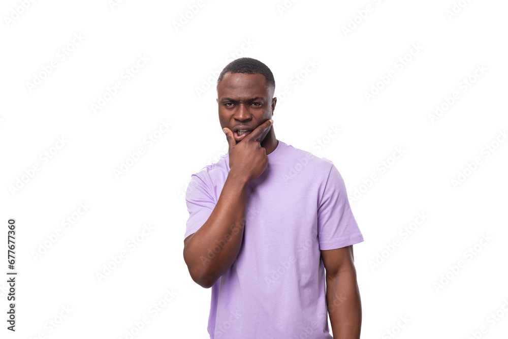 young authentic american guy dressed in a light lilac t-shirt on a white background young authentic american guy dressed in a light lilac t-shirt on a white background