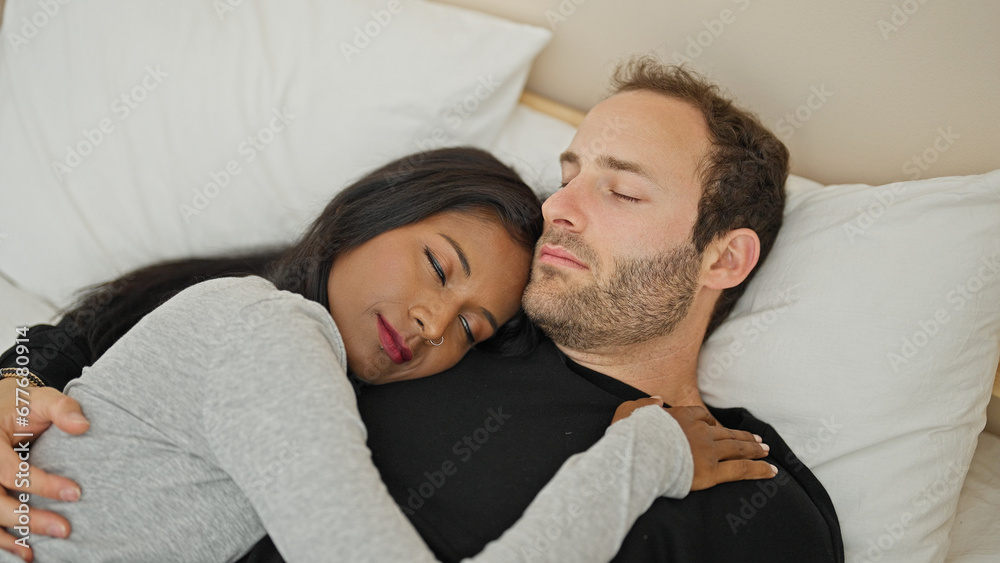 Beautiful couple lying on bed hugging each other sleeping at bedroom Beautiful couple lying on bed hugging each other sleeping at bedroom