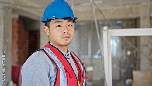  builder standing with serious expression at construction site