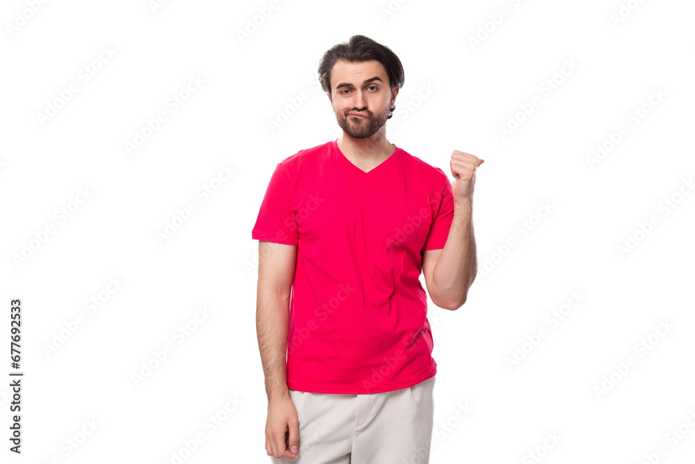 young pleasant slender brunette man with a cool hairstyle is dressed in a red t-shirt with a mock-up for printing on fabric young pleasant slender brunette man with a cool hairstyle is dressed in a red t-shirt with a mock-up for printing on fabric