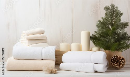 Empty template with set of towels and candles near Christmas tree with copyspace