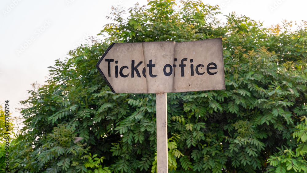 An aging ticket office sign outdoors
