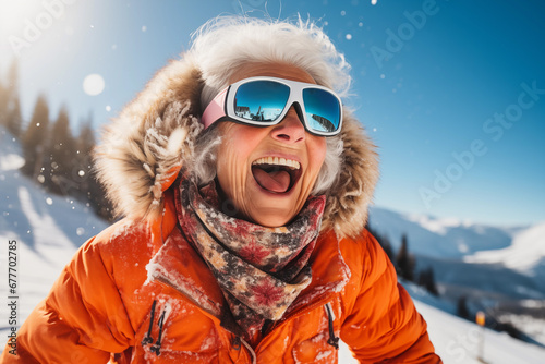 A smiling old woman on the ski slopes in a winter sunny day.