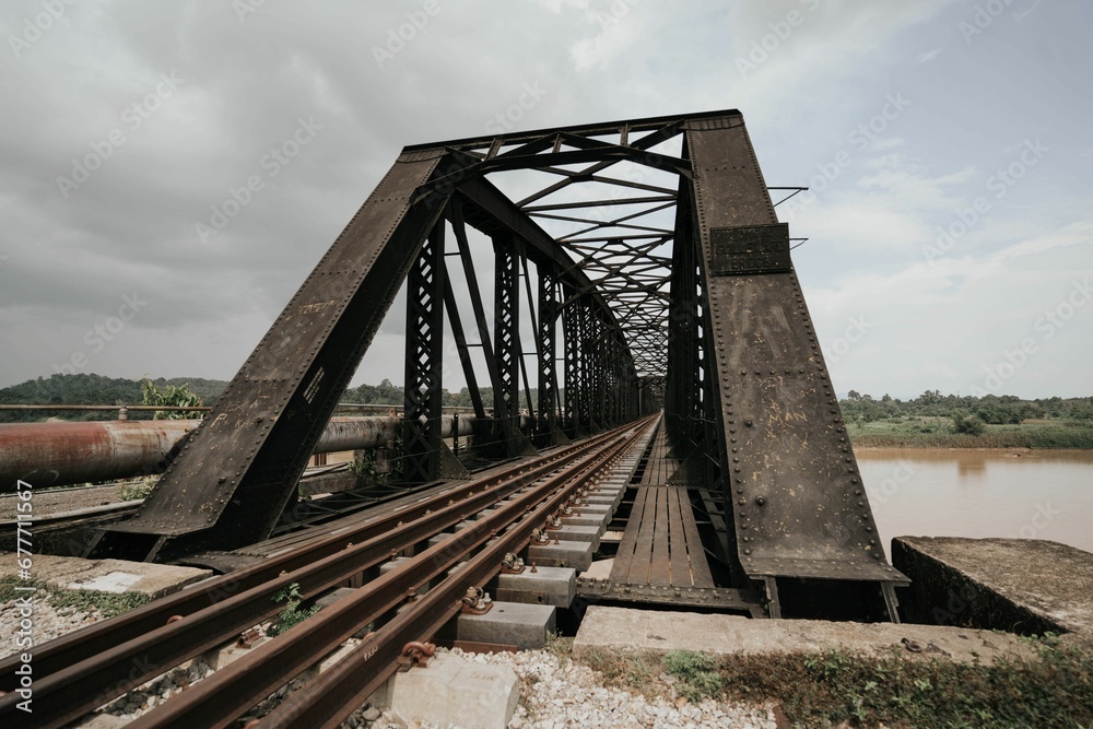 Tall steel bridge with a railway over the river