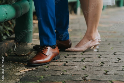Man and woman's feet wearing a shoes and sandals