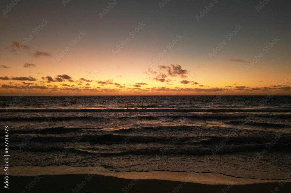 Beautiful shot of sea waves rolling on the shore during sunset