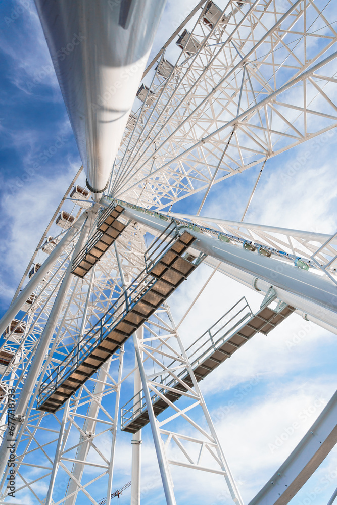 Big tall white ferris wheel in front of perfect blue sky in Bukovel. Carpathians Ukraine