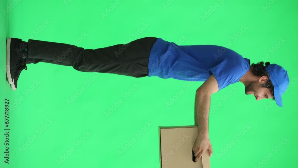 full-length male courier holding a box on a green background